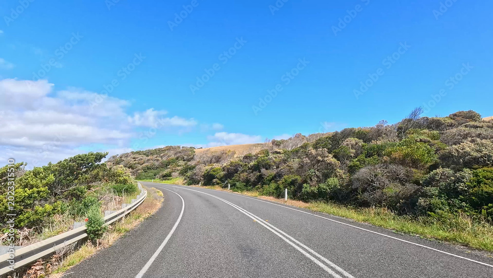 Obraz premium Winding Asphalt Road Along the Great Ocean Road in Victoria Australia