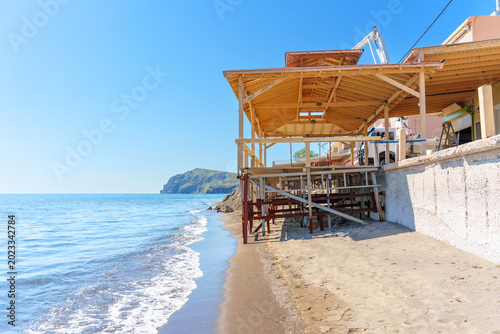 Quadro su tela Wooden beach terrace on the sandy shore of Skala Eresou, Lesvos, Greece