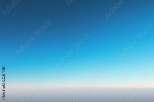 Serene clear blue sky at twilight over a calm horizon