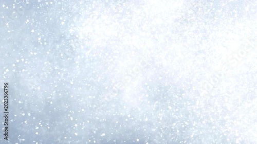 Abstract motion of shimmering white particles against light blue and dark backgrounds, creating dynamic glitter effect in sparkling cosmic footage.