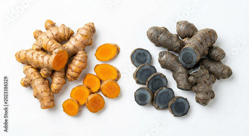 Fresh whole and sliced turmeric roots on white background