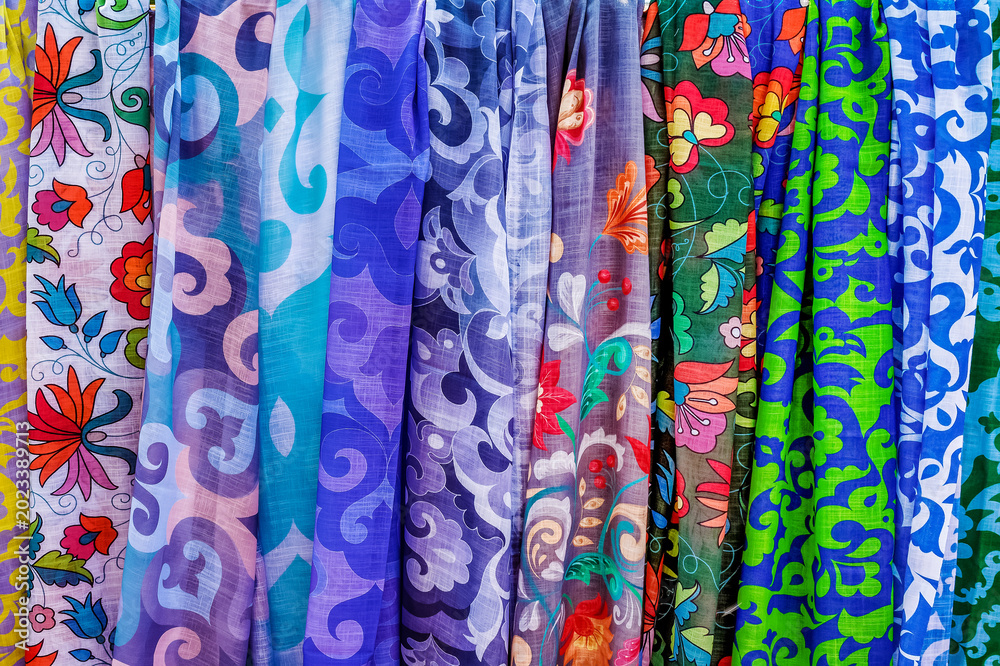 Fototapeta premium The sale of colorful women's kerchiefs at a street festival.