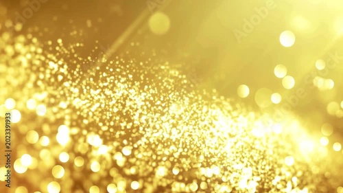 Golden bokeh background with shimmering particles floating in light rays creating elegant festive atmosphere for luxury celebration awards and motion.