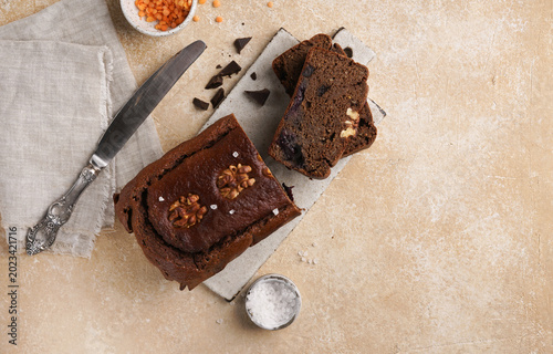 Flat lay of healthy lentil brownies with walnuts and sea salt, high protein gluten free chocolate loaf cake with copy space
