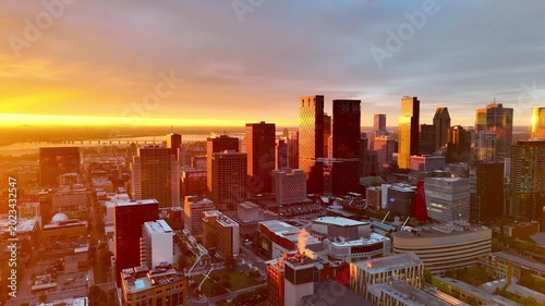 Vibrant sunrise over Montreal skyline with St Lawrence River and La Grande Roue reflecting colorful evening sky. g.