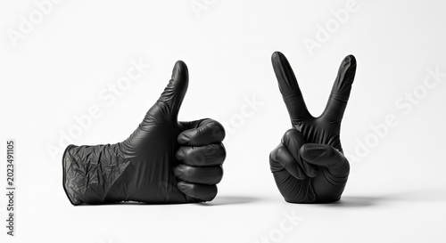 Black gloved hands showing thumbs up and peace sign on white background