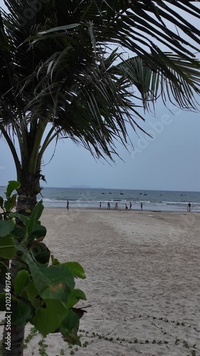 People walk along My Khe Beach in Da Nang