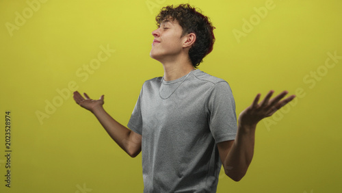 Foto Teenage boy smiling with open hands and arms outstretched in studio, eyes closed and relaxed; joy freedom