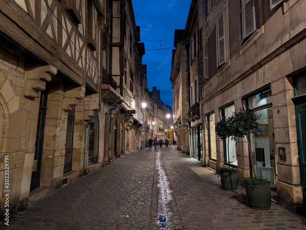 Fototapeta premium Street and timber framing houses in historic downtown Dijon at night, France - May 2026