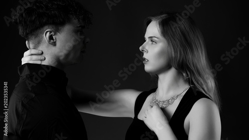 Woman and man facing each other, expressing intimacy and connection in monochrome
