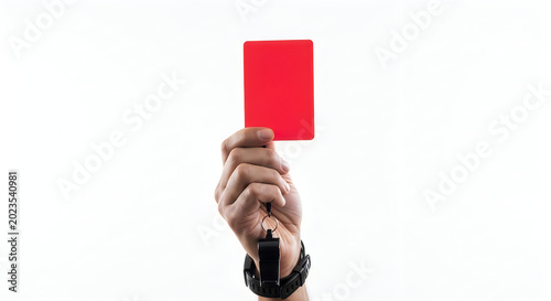 Referee holding red card and whistle sports penalty concept