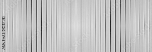 Foto grey silver gray corrugated metal wall background texture with vertical lines and rivets