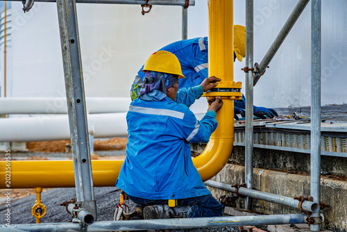 Production operator opening bolt refinery plant equipment for pump pipe line yellow oil