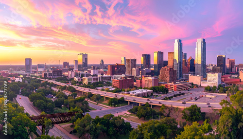 Vibrant Kansas City Skyline at Sunset with Dramatic Clouds and City Lights.