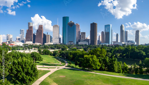 Houston Skyline with Lush Green Park and Blue Sky.