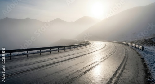Winding icy road through foggy mountains in winter