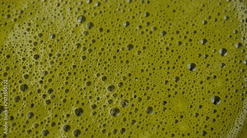 Matcha tea foam texture macro, rotation