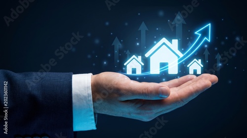 Hand holds luminous house icons with upward arrow, symbolizing real estate growth and investment