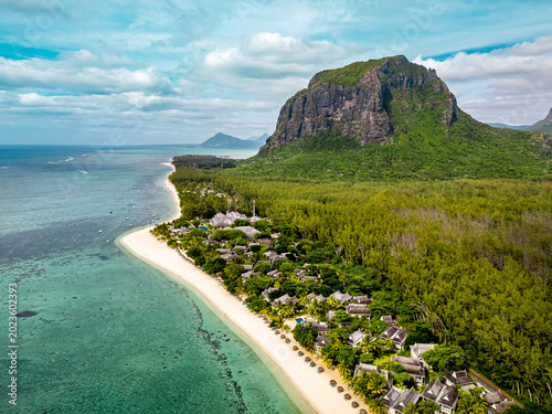 Aerial drone view of Le Morne Brabant and the pristine Le Morne Beach in Mauritius, featuring turquoise lagoon, white sand and dramatic coastal landscape