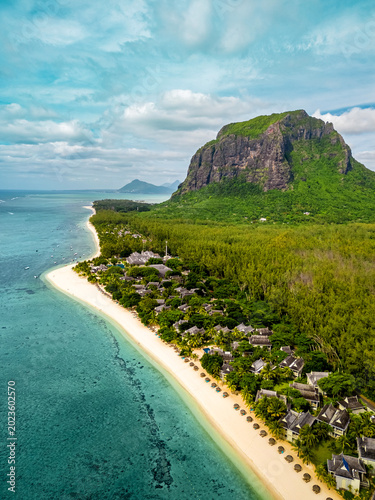 Aerial drone view of Le Morne Brabant and the pristine Le Morne Beach in Mauritius, featuring turquoise lagoon, white sand and dramatic coastal landscape