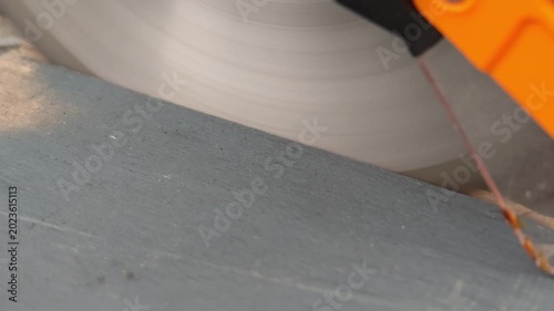Close-up of cutting wood with an electric saw. Woodwork, carpentry