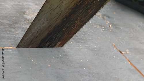 Close-up of cutting wood with a hacksaw or a saw. Woodwork, carpentry