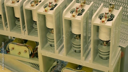 Ceramic insulators and transformers in high-voltage equipment are presented at the exhibition. Closeup. Shot in motion 