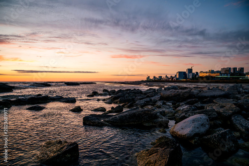 A soft pink sunset over the Caspian Sea coast and the city of Aktau on the horizon