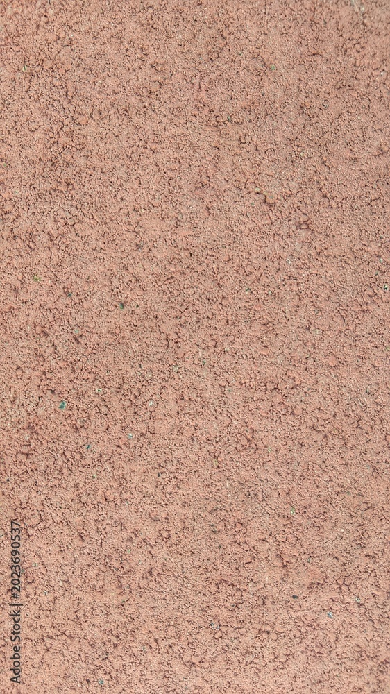 Fototapeta premium ​Reddish brown textured stucco wall surface close up