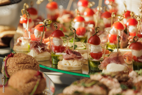 Fotografie Assorted Italian appetizers on mirrored tray at luxury buffet