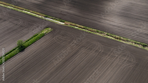 Photos Aerial high angle view of freshly plowed agricultural soil and drainage ditch co