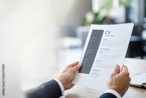 Recruitment process overview human resources hiring office setting cv review blurred background professional insight
