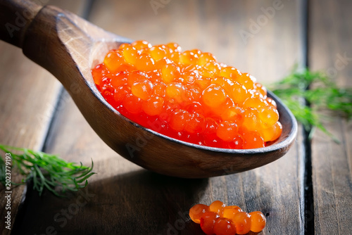 Икра красная-зернистая, полезный и вкусный морепродукт в деревянной ложке.