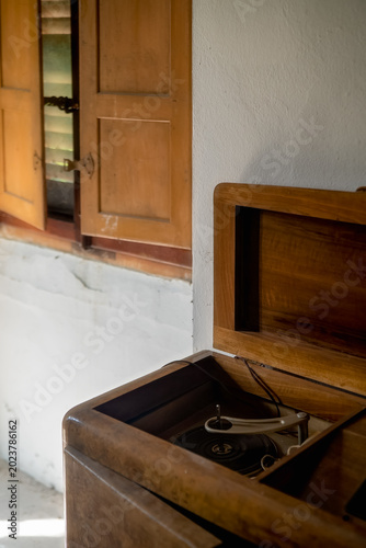 Vintage wooden radio or phonograph cabinet in abandoned interior