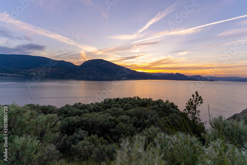Penticton Okanagan Lake Sunset With Silt Cliffs And Kvr Trails, Scenic Canadian Landscape Views At Dusk