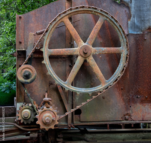 Canvas Print Gears, wheels, and other components of an antique hay press (baler) or a similar heavy-duty threshing machine