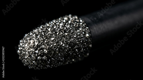 Detailed close-up of a high-speed dental diamond bur tip on black background highlighting the abrasive surface for precision tooth shaping and restorative clinical procedures in modern dentistry.