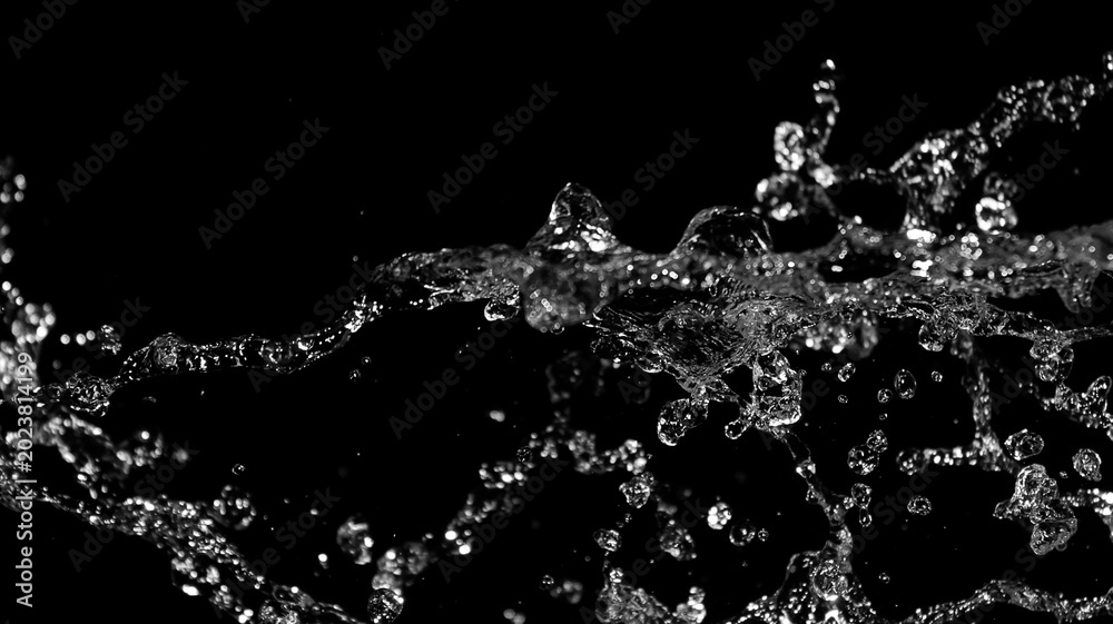 Obraz premium Dynamic Water Splash with High Contrast Against Black Background