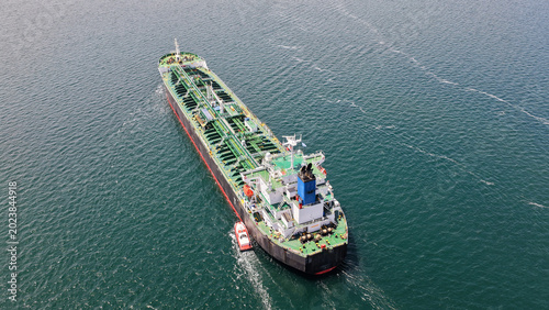 Aerial drone photo of crude Oil tanker ship underway towards open sea, a merchant ship specially designed for chemical products transportation