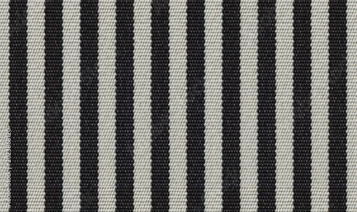Black and white striped fabric texture. High resolution close-up of vertical stripes textile.