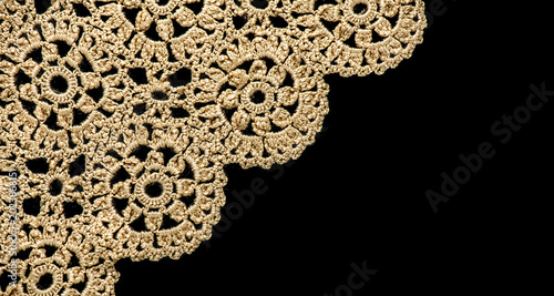 Crochet lace patterns, crocheted Grandmas Doily, Detail of hand-crocheted tablecloth isolated on black background border art design. Craft, vintage linen. Hobby concept. flat lay. 