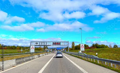 Polizeikontrolle auf der Autobahn A7 bei Füssen mit Verkehrszeichenbrücke im Herbst