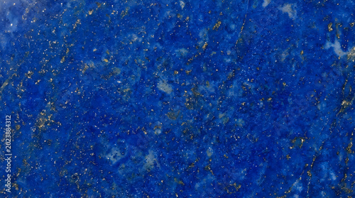 Natural blue lapis lazuli stone texture with gold flecks for luxury jewelry design and ancient mineral collection frontal view background perfectly high resolution