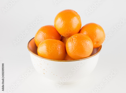white plate filled with ripe juicy tangerines
