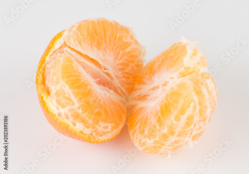Slices of yellow ripe tangerine isolated