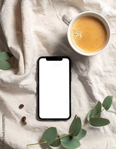 Smartphone and coffee on fabric.