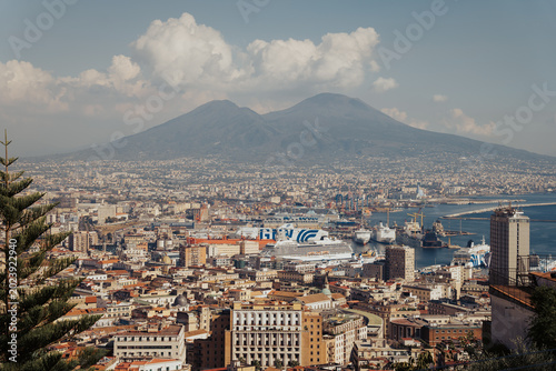 Panoramic view of the old town of Naples, Italy, with historic buildings, rooftops, and the Bay of Naples seen from the Sant'Elmo castle viewpoint