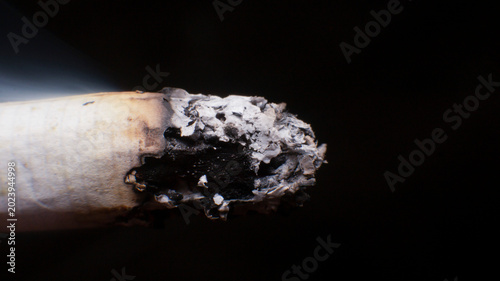 Konstfotografi Close-up of a smoldering cigarette burning with ash falling
