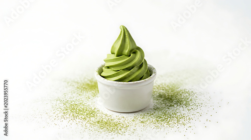 Bright green matcha soft serve ice cream in a small white cup with powdered matcha on a white background close up detailed texture fresh