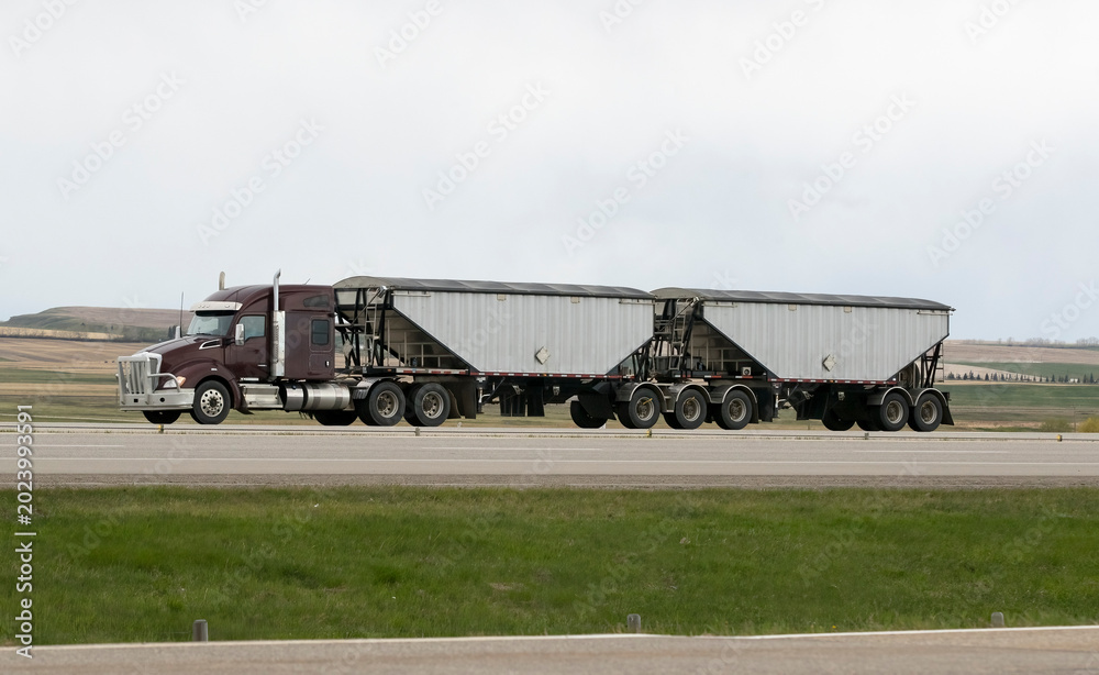 Fototapeta premium Heavy Cargo on the Road. A truck hauling freight along a highway